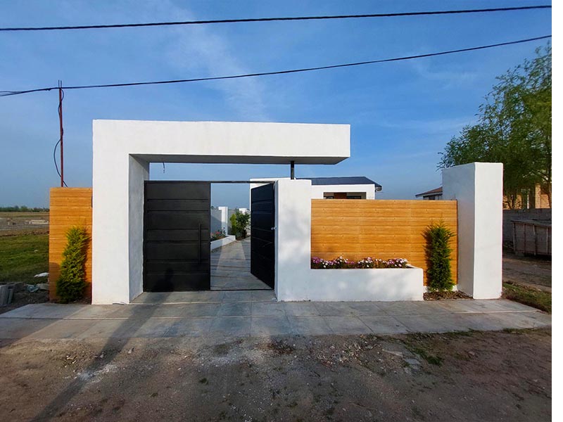 تصویر یک ویلای نما مدرن و محوطه سازی شده با موزاییک و چمن مصنوعی