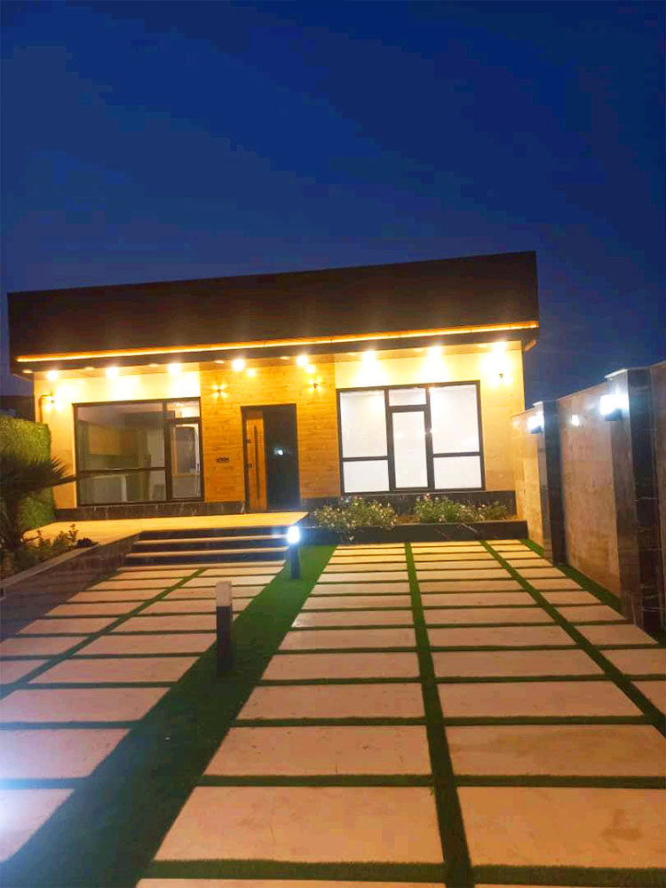 تصویر یک ویلای نما مدرن و محوطه سازی شده با موزاییک و چمن مصنوعی