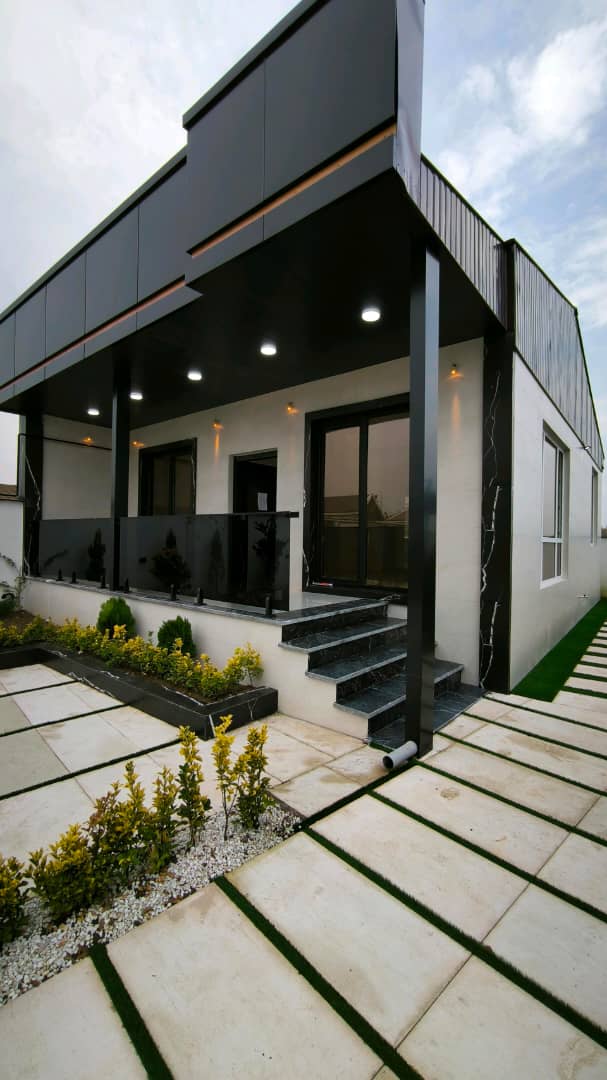 تصویر یک ویلای نما مدرن و محوطه سازی شده با موزاییک و چمن مصنوعی