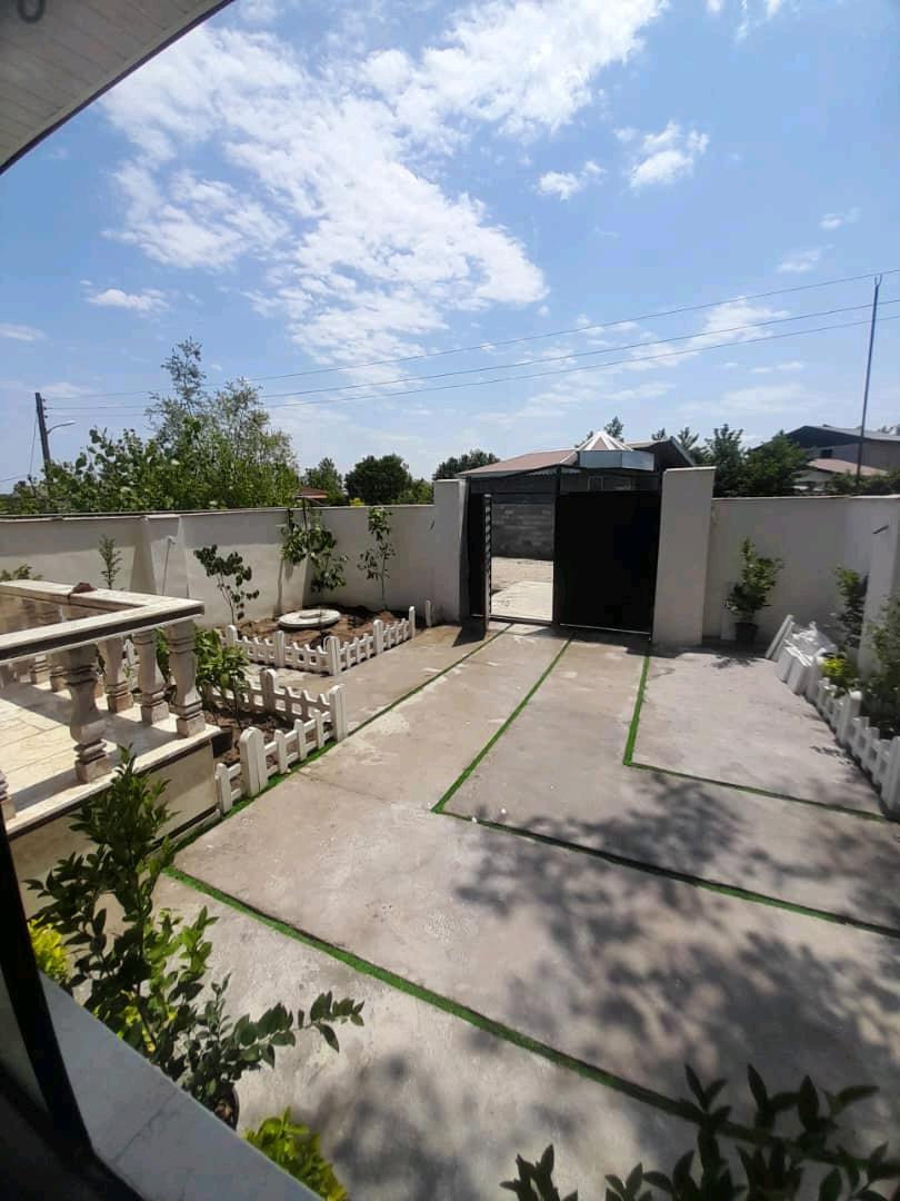 تصویر یک ویلای نما مدرن و محوطه سازی شده با موزاییک و چمن مصنوعی