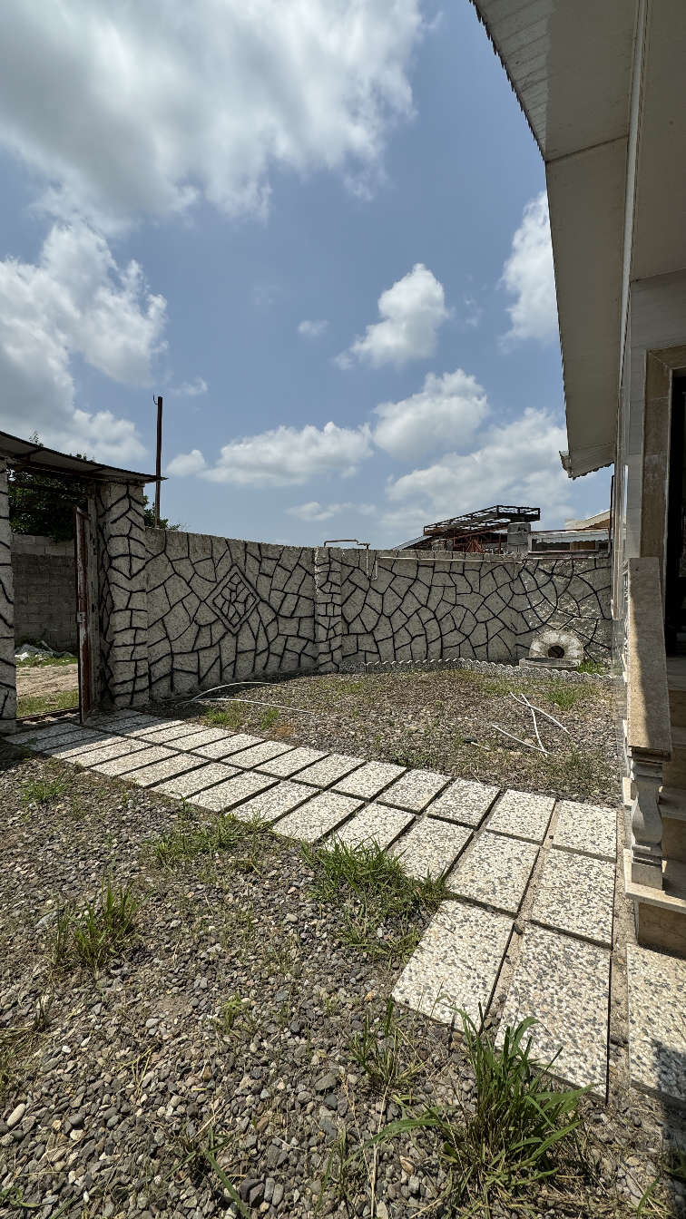 تصویر یک ویلای فلت روستایی که محوطه سازی شده و از چمن مصنوعی استفاده شده